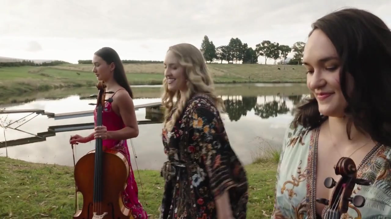 Chamber musicians with their instruments beside a lake at a music festival