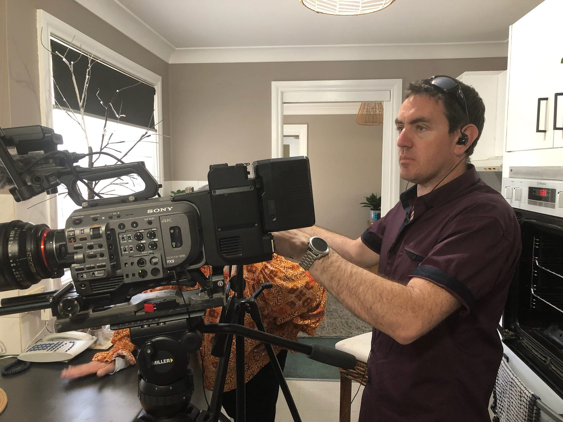 Evan Zell with a Sony FX9 on a shoulder rig on set