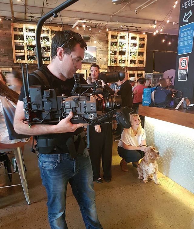 Evan on a Steadicam vest in a restaurant with a client