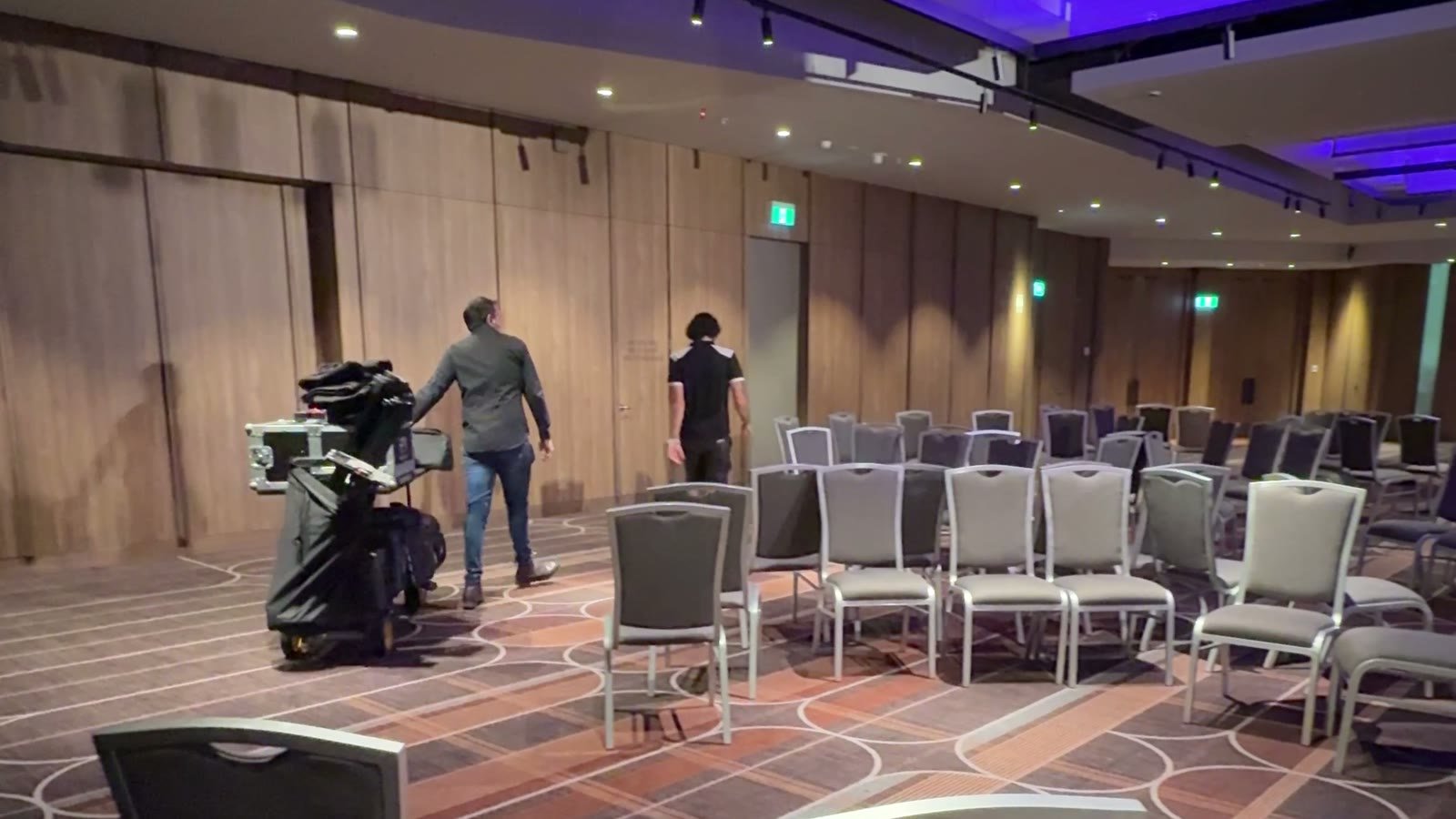 Broadcast camera on a pedestal in a club function room during load-in