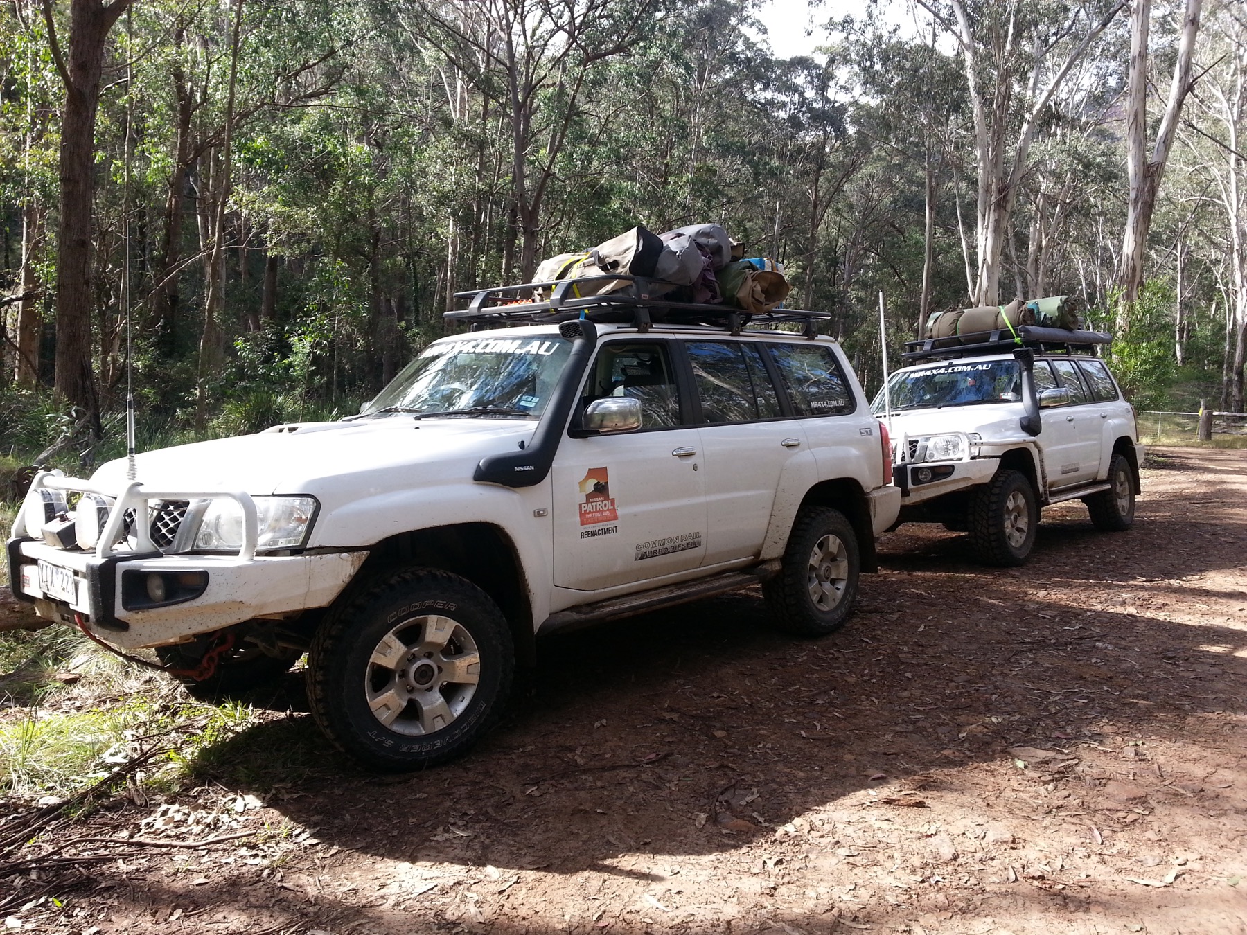 Four wheel drives with roof racks on an outback track