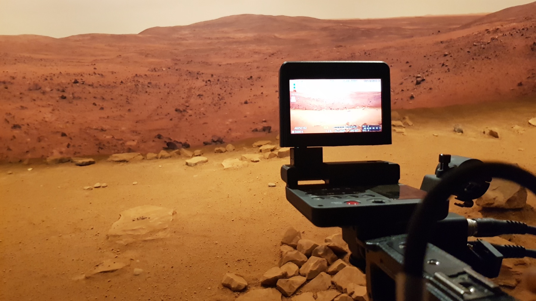 Camera and monitor on red outback earth