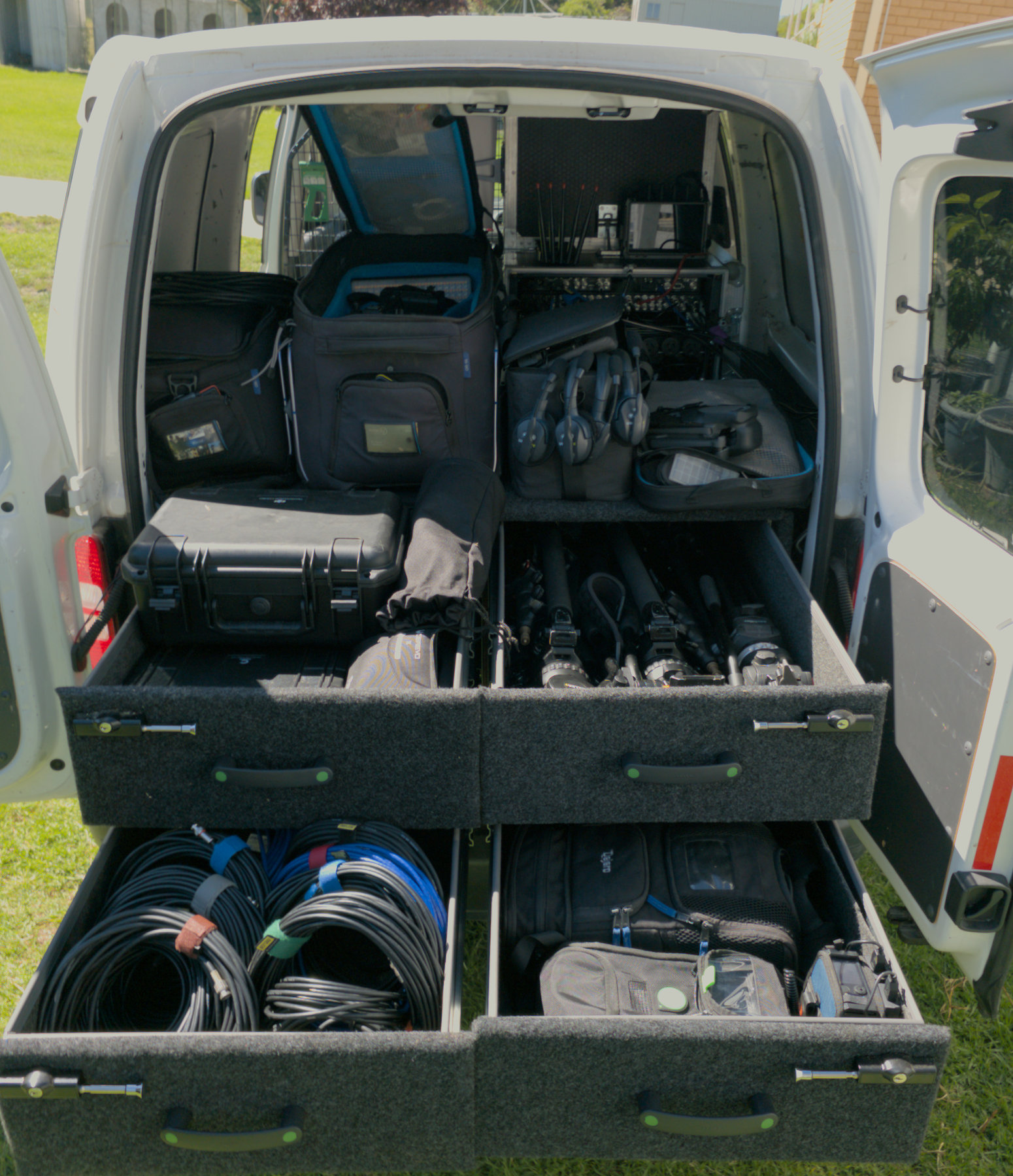 The back of a van full of camera cases